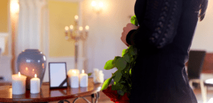 Mourning Woman with lit candles and urn