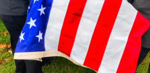 United States Flag draped over casket during a funeral
