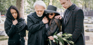 Grieving family dressed in black at an end-of-life ceremony.