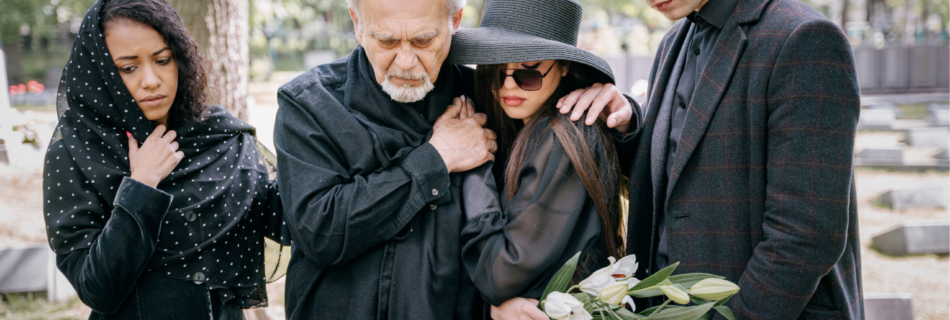 Grieving family dressed in black at an end-of-life ceremony.