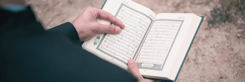 back of a person with a prayer book open to a page.