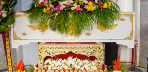 A Buddhist funeral white casket with flower arrangement