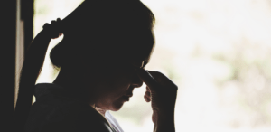 Shadow of grieving person after a loved one dies from suicide