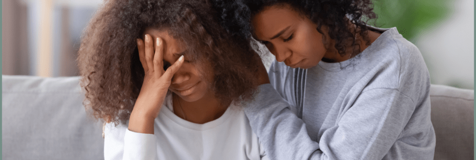 woman consoling another woman