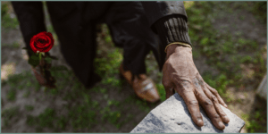 Hand touching a tombstone